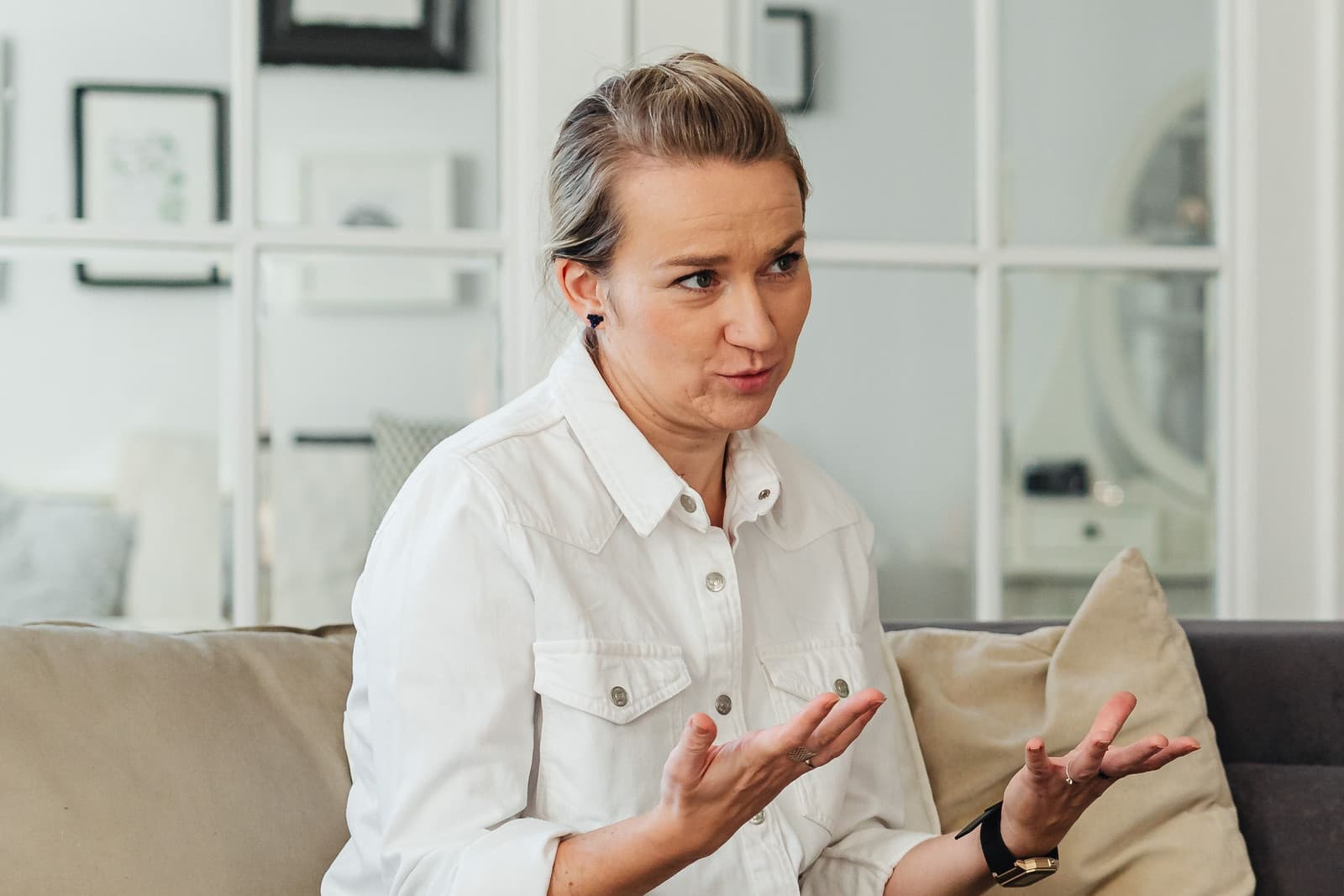 A woman speaking with her hands open during a coaching session